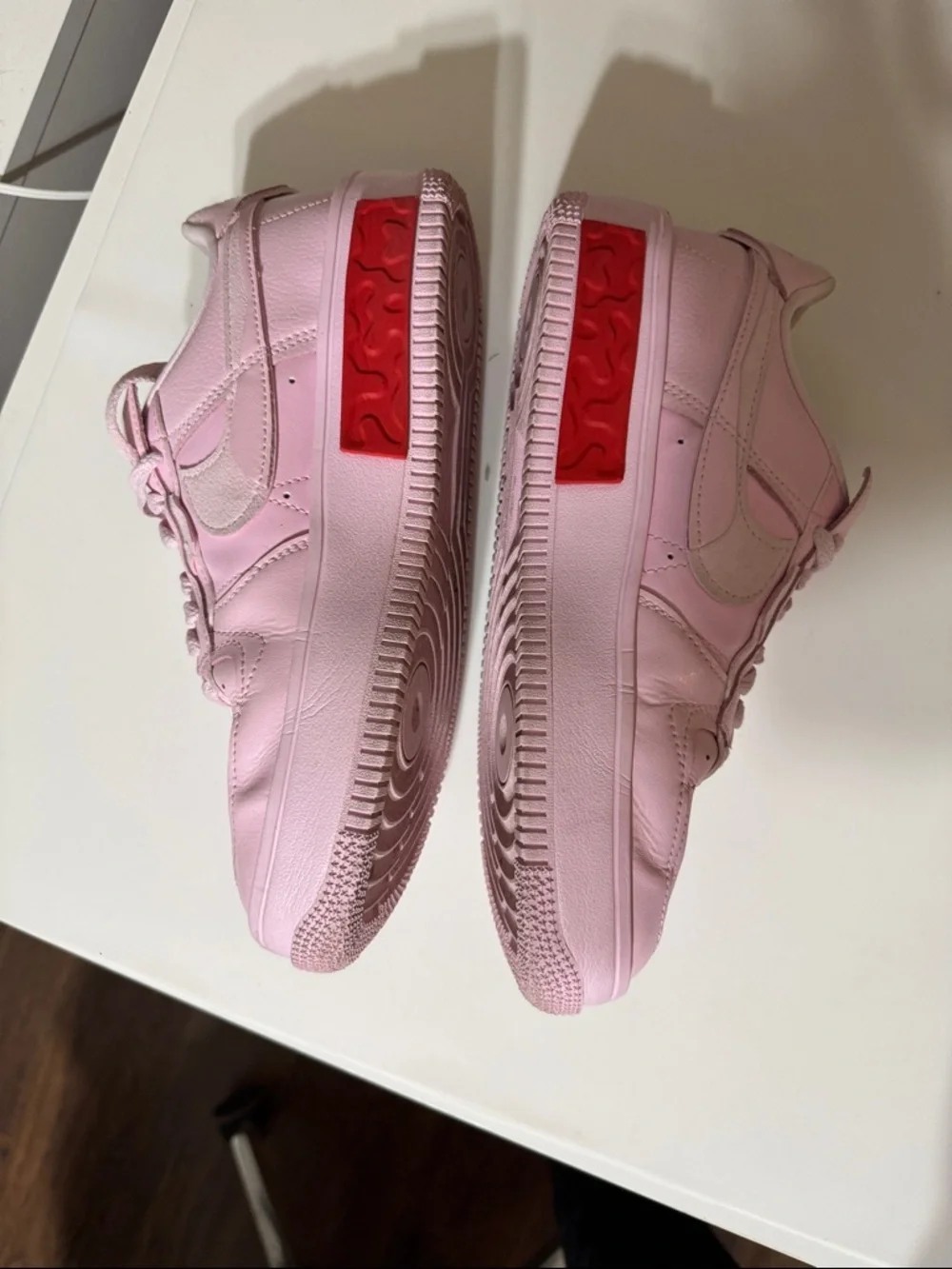 Nike Women’s Pink Low-Top Sneakers with Red Accent